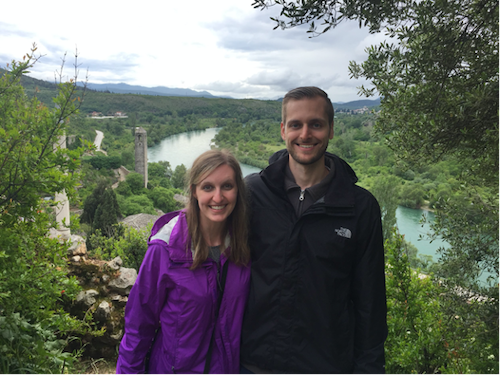 Dr. Keenan Fischman and his wife standing outside near a river