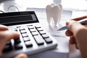 calculator and paper with tooth on the paper